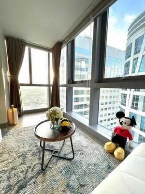 a living room with a teddy bear sitting in a window at Funky HQ - 1BR Eastwood Global Plaza in Manila