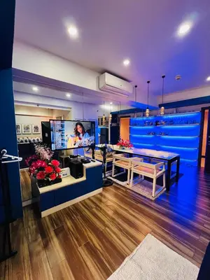 a living room with a table and a tv at Pinecrest Residential Condominium Newport Pasay City in Manila