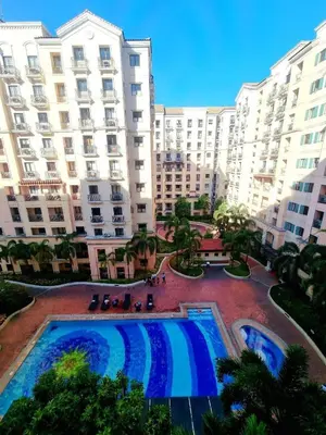 an overhead view of a large building with two pools at Pinecrest Residential Condominium Newport Pasay City in Manila