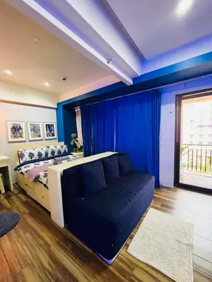 a blue bedroom with a bed and a couch at Pinecrest Residential Condominium Newport Pasay City in Manila