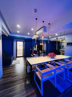 a living room with a table and blue walls at Pinecrest Residential Condominium Newport Pasay City in Manila