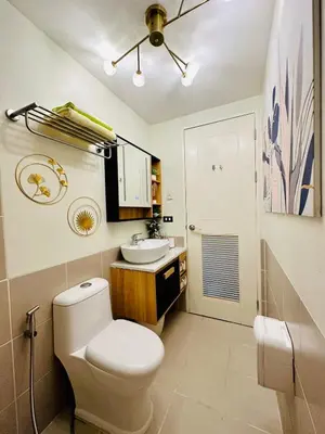a bathroom with a toilet and a sink at Cozy Escape Satori Residences Santolan in Manila