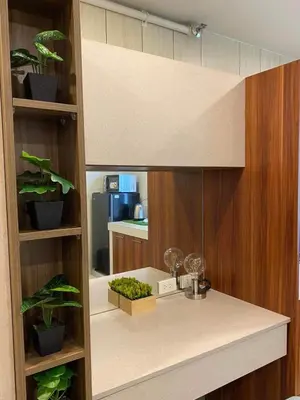a kitchen with a counter with potted plants at Cozy Studio Sorrento Oasis Rosario Pasig in Manila