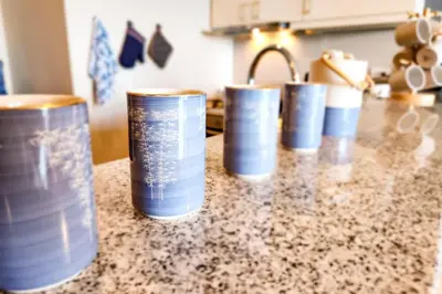 a row of tin cans sitting on a kitchen counter at Travellers Haven 3br BGC, Bathtub, XBOX, 200mbps in Manila