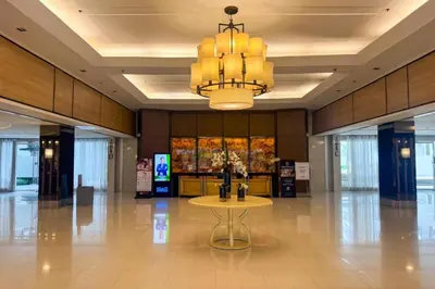 a lobby with a table in the middle of a building at Spacious 2br 110sqm, near MOA, PS4, Printer in Manila