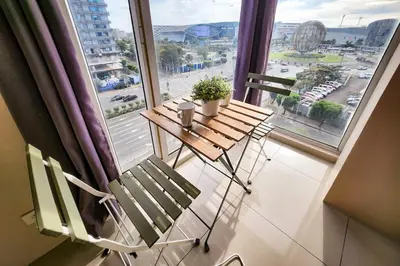 two chairs and a table in front of a window at Spacious 2br 110sqm, near MOA, PS4, Printer in Manila