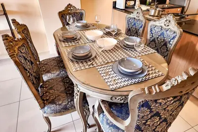 a dining room table with plates and dishes on it at Spacious 2br 110sqm, near MOA, PS4, Printer in Manila