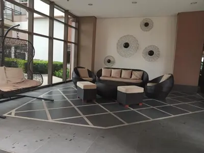 a living room with a couch and two chairs at Radiance manila bay in Manila