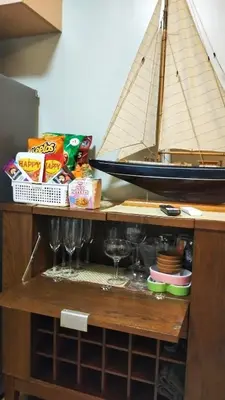 a wooden cabinet with a sail boat on top of it at Flair Towers Urban Resort Staycations in Manila