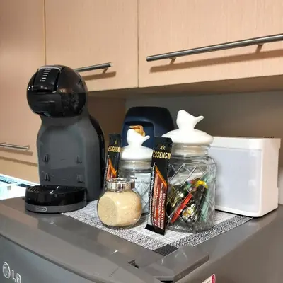 a kitchen counter top with a coffee maker andacistacist at Flair Towers Urban Resort Staycations in Manila