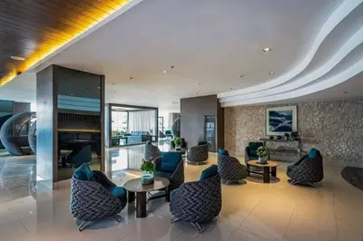 a lobby with chairs and tables in a building at EmFress Suites in Manila