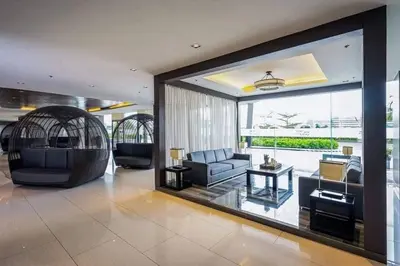 a living room with a couch and a table at EmFress Suites in Manila