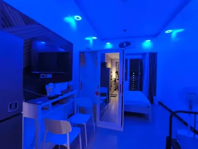 a living room with blue lights in a room at EmFress Suites in Manila