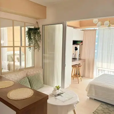 a bedroom with a bed and a table in a room at Rio West Tower - Azure Urban Resort Residences in Manila