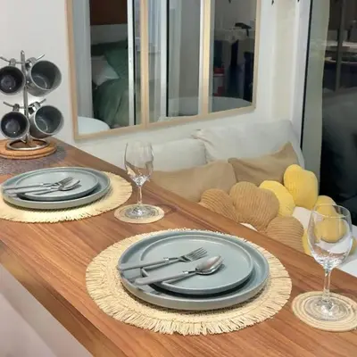 a table with plates and silverware on a table at Rio West Tower - Azure Urban Resort Residences in Manila