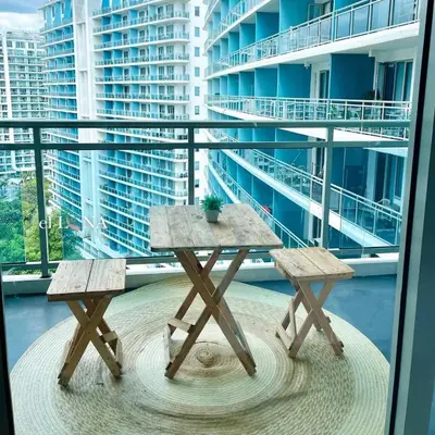 two picnic tables on the balcony of a building at Rio West Tower - Azure Urban Resort Residences in Manila