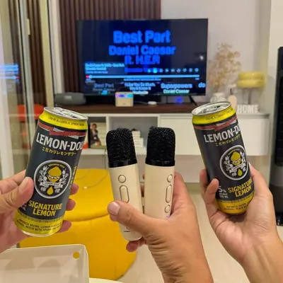 two people holding up two bottles of kennforth dj and a microphone at Rio West Tower - Azure Urban Resort Residences in Manila