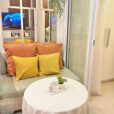a living room with a couch with a table at Rio West Tower - Azure Urban Resort Residences in Manila