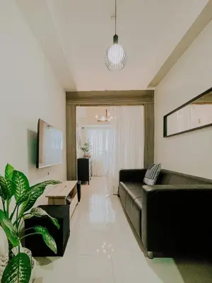 a living room with a couch and a table at 2Br Cozy Unit near Manila International Airport in Manila