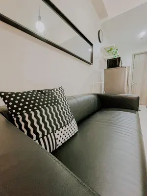 a couch with a pillow on it in a living room at 2Br Cozy Unit near Manila International Airport in Manila