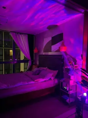a purple bedroom with a bed with a purple ceiling at SerenityPads in Manila