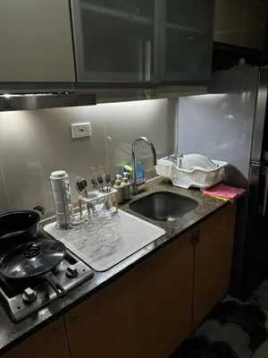 a kitchen counter top with a sink and a sink at Serenity Pads in Manila