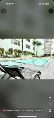 a view of a swimming pool with a bench at Stanford Suites 1 in Silang