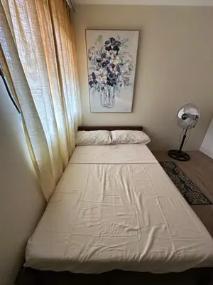 a bed in a room with a window at Stanford Suites 1 in Silang