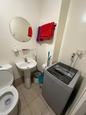 a small bathroom with a toilet and a sink at Stanford Suites 1 in Silang