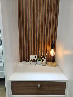 a white counter with a lamp on top of it at Condo in Coast Residences, Pasay City in Manila