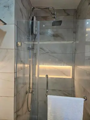 a shower with a glass door with a white towel at Condo in Coast Residences, Pasay City in Manila