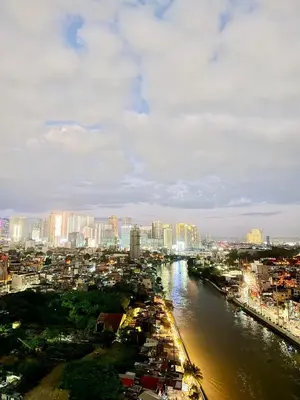 a view of a city with a river and buildings at Studio Unit Staycation near Rockwell Mandaluyong FREE Pool Access in Manila