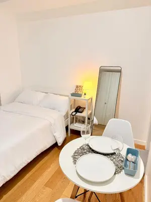 a bedroom with a bed and a table and chairs at Studio Unit Staycation near Rockwell Mandaluyong FREE Pool Access in Manila