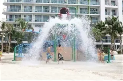 three children playing in a fountain on the beach at Man-made beach waves 19 minutes from NAIA in Manila