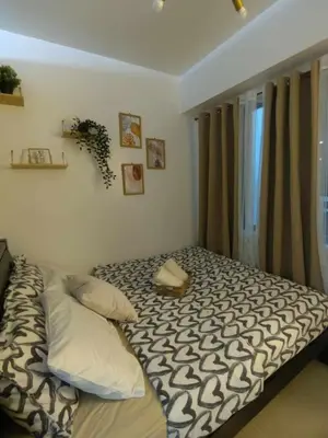 a bed in a room with a window at Mk Luxury Staycation in Manila