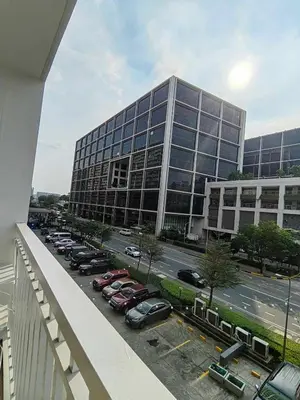 a large building with cars parked in a parking lot at Mk Luxury Staycation in Manila