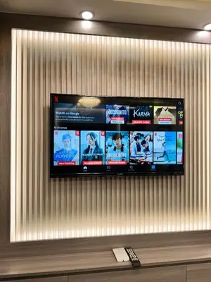 a flat screen tv hanging on a wall at Milagrosa Shore 3 residences in Manila