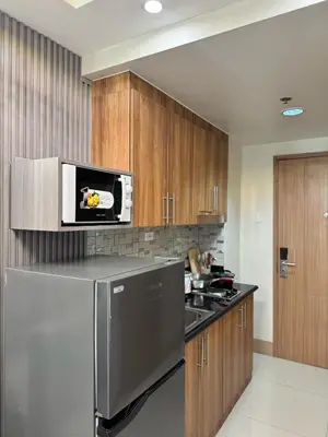 a kitchen with a stainless steel refrigerator and a microwave at Milagrosa Shore 3 residences in Manila