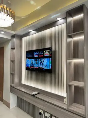 a flat screen tv on a wall in a lobby at Milagrosa Shore 3 residences in Manila