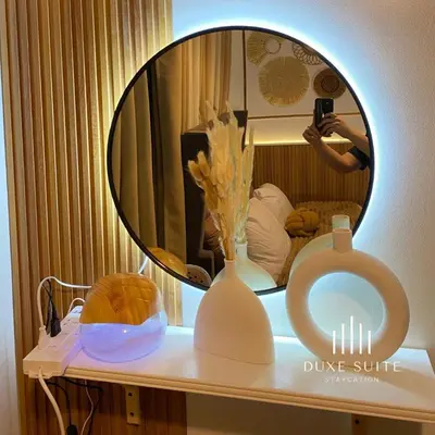 a person taking a picture of a mirror on a table at Cozy Vibes near Moa & Naia Airport Wifi Netflix-Duxe8 in Manila
