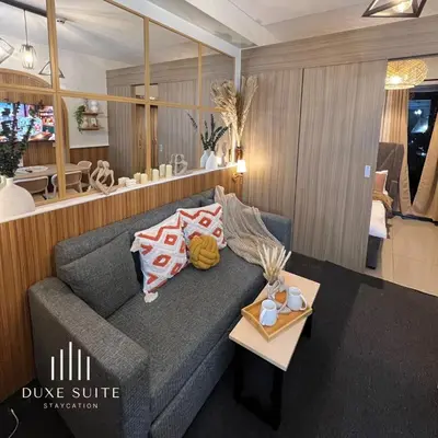 a living room with a couch and a table at Cozy Vibes near Moa & Naia Airport Wifi Netflix-Duxe8 in Manila