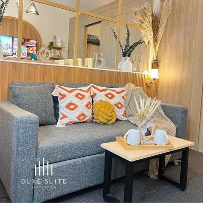 a living room with a blue couch and a coffee table at Cozy Vibes near Moa & Naia Airport Wifi Netflix-Duxe8 in Manila