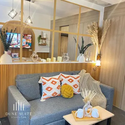a living room with a blue couch and a table at Cozy Vibes near Moa & Naia Airport Wifi Netflix-Duxe8 in Manila