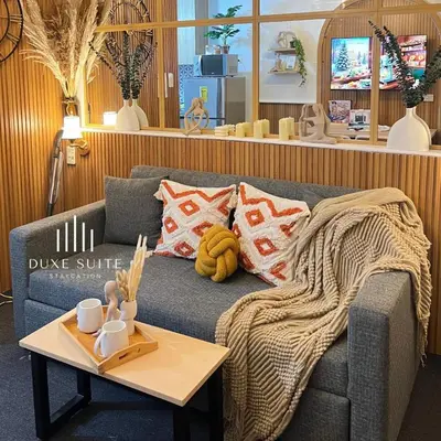a living room with a couch and a coffee table at Cozy Vibes near Moa & Naia Airport Wifi Netflix-Duxe8 in Manila