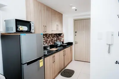 a kitchen with a refrigerator and a microwave at Staycation near Moa new room in Manila