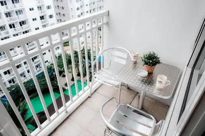 a balcony with a table and chairs on a balcony at Staycation near Moa new room in Manila