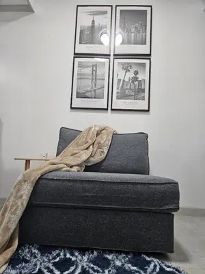 a bed in a room with pictures on the wall at Downtown Makati Malls and Bars at your doorsteps in Manila