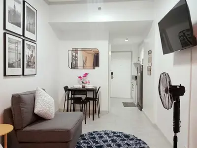 a living room with a couch and a table at Downtown Makati Malls and Bars at your doorsteps in Manila