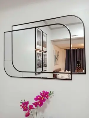 a mirror hanging on a wall with purple flowers at Downtown Makati Malls and Bars at your doorsteps in Manila