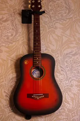 a guitar is hanging on a wall at Eccentric Escape Stylish Makati Urban Swim Gym 4034 in Manila
